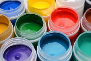 Different colors gouache paint jars set. Macro shot top view